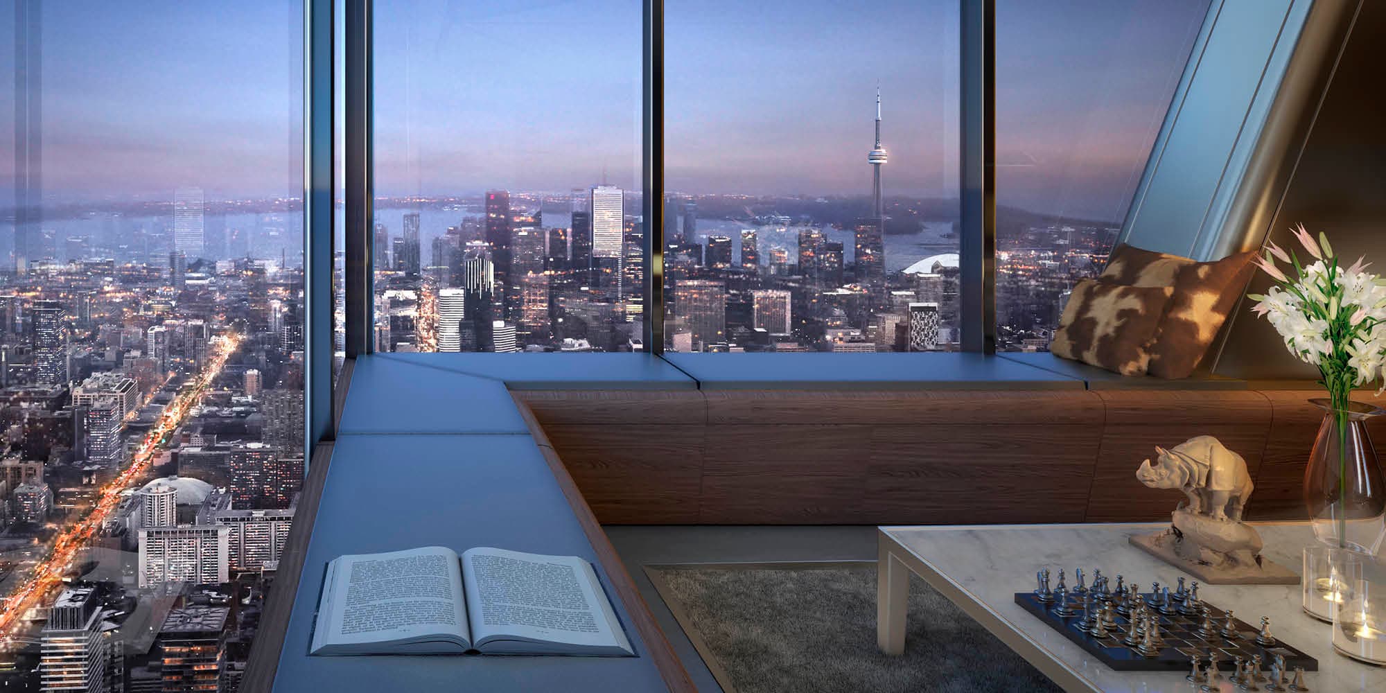 A One Bloor West penthouse interior at dusk, the CN Tower and city spread out below